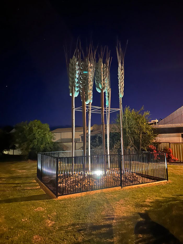 Strategic placement of a bespoke link-light for an existing steel wheat sculpture.
