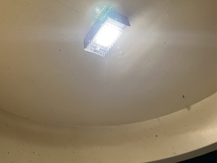 A close-up view of a Leadsun road light installed in the ceiling of a bus shelter with protective cage cover to reduce the risk of vandalism.