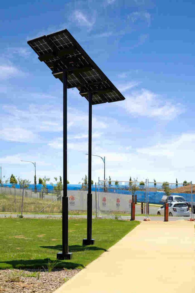 A leadsun solar pathway light stands in the foreground on the edge of the Gables Riparian Corridor pathway - unlit during the day.